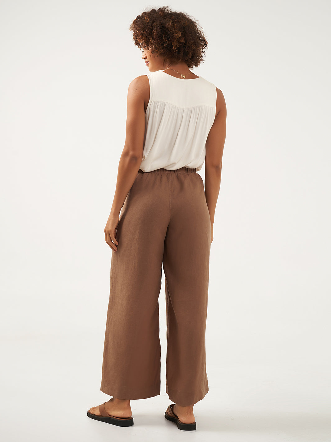 Model is wearing Sundara Linen Pants in Desert Sand