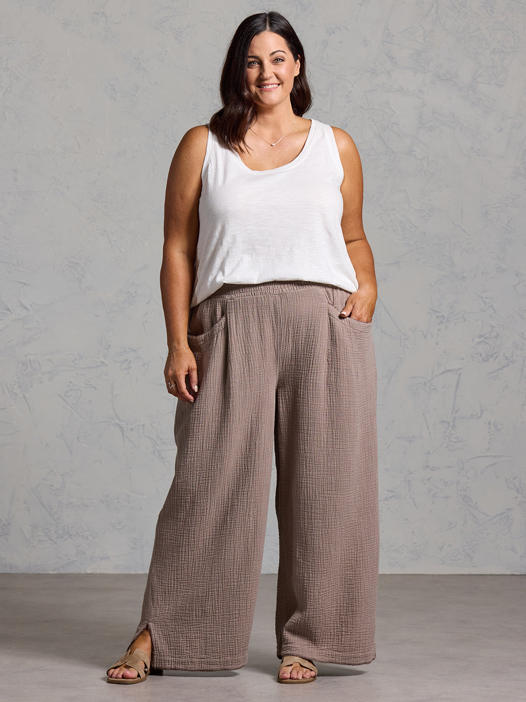 A woman wearing Sur Mer Organic Cotton Pants Elm and Yarra Cotton Top Coconut from Nomad the Label