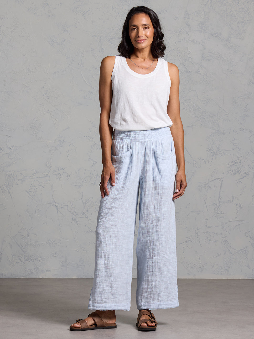 A woman wearing Sur Mer Organic Cotton Pants Serene Blue and Yarra Cotton Top Coconut from Nomad the Label