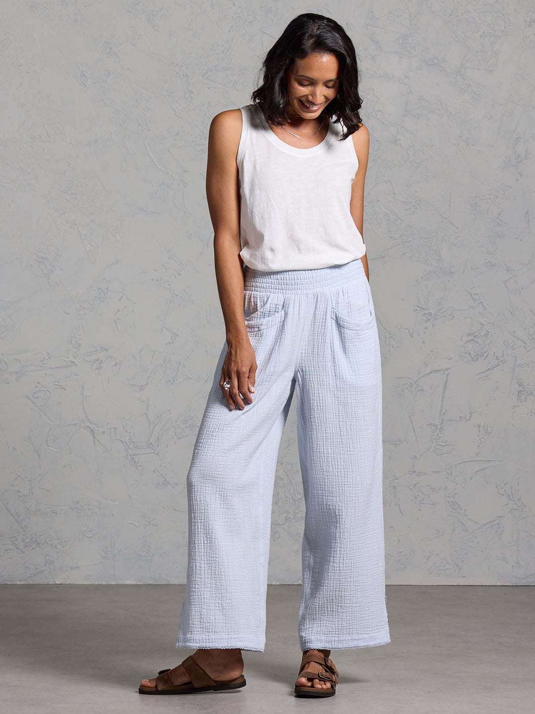 A woman wearing Sur Mer Organic Cotton Pants Serene Blue and Yarra Cotton Top Coconut from Nomad the Label