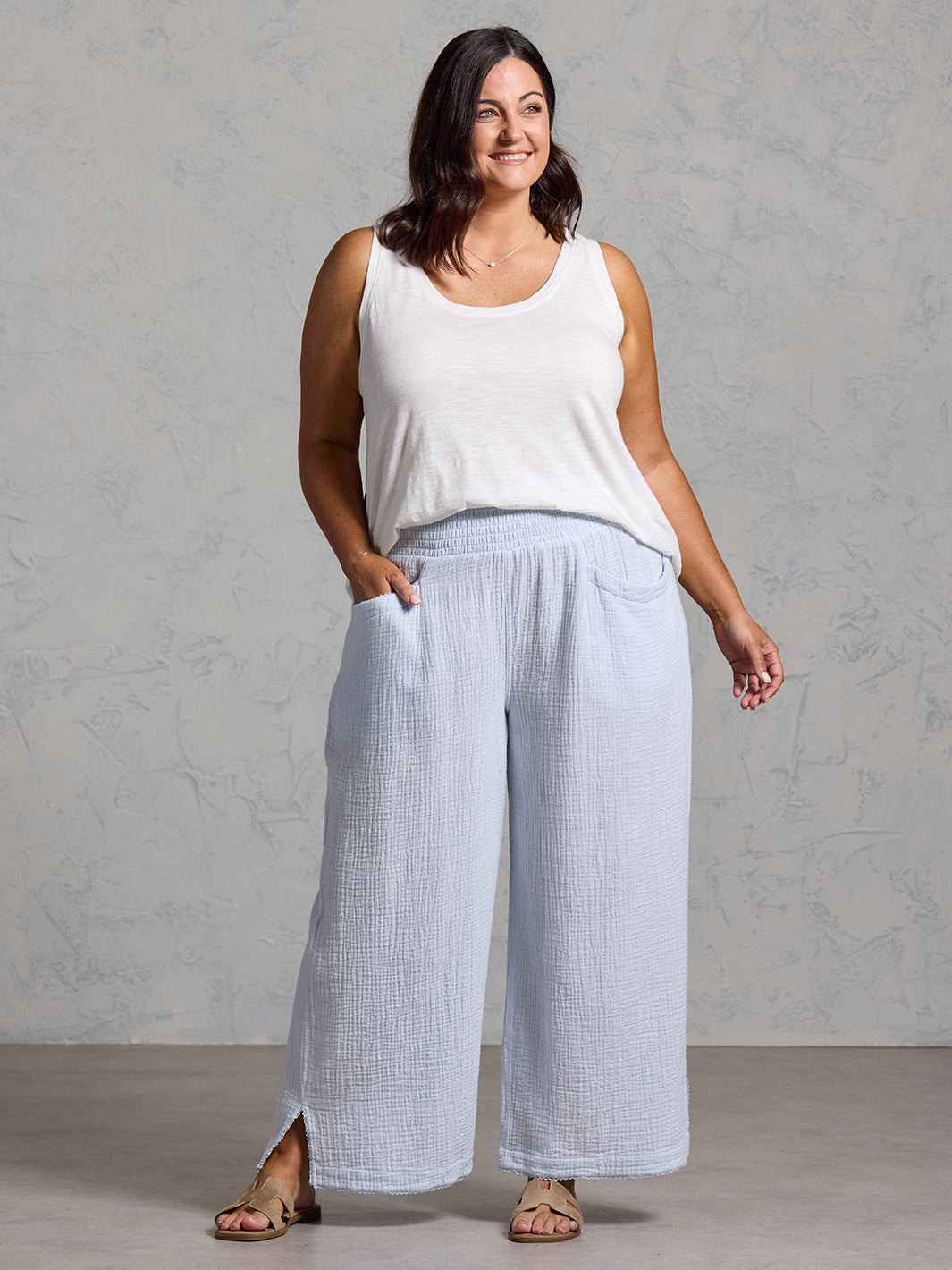 A woman wearing Sur Mer Organic Cotton Pants Serene Blue and Yarra Cotton Top Coconut from Nomad the Label
