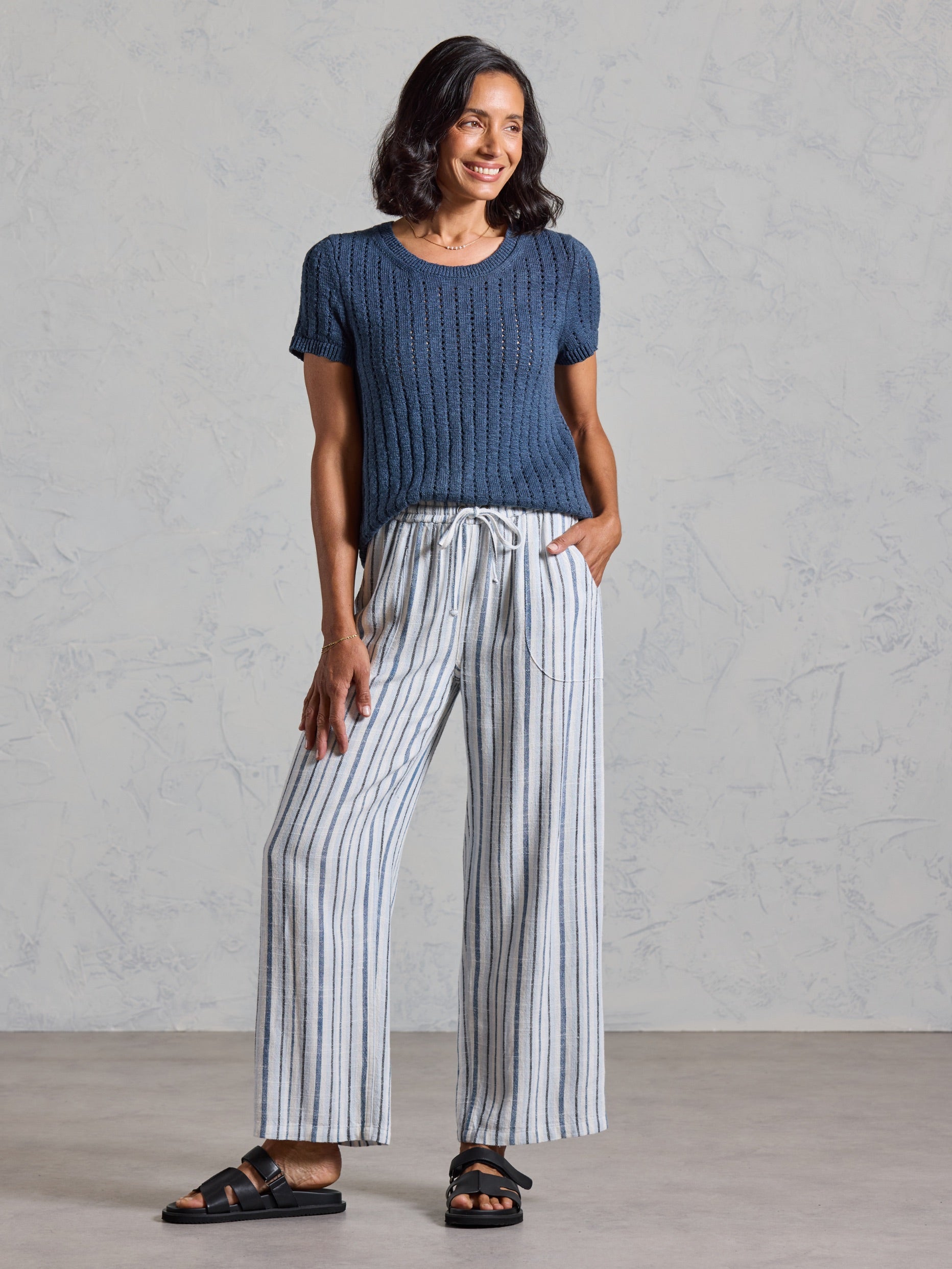 Full length view of the Jolie Linen Blend Pants in coastal blue, paired with a navy knit top.