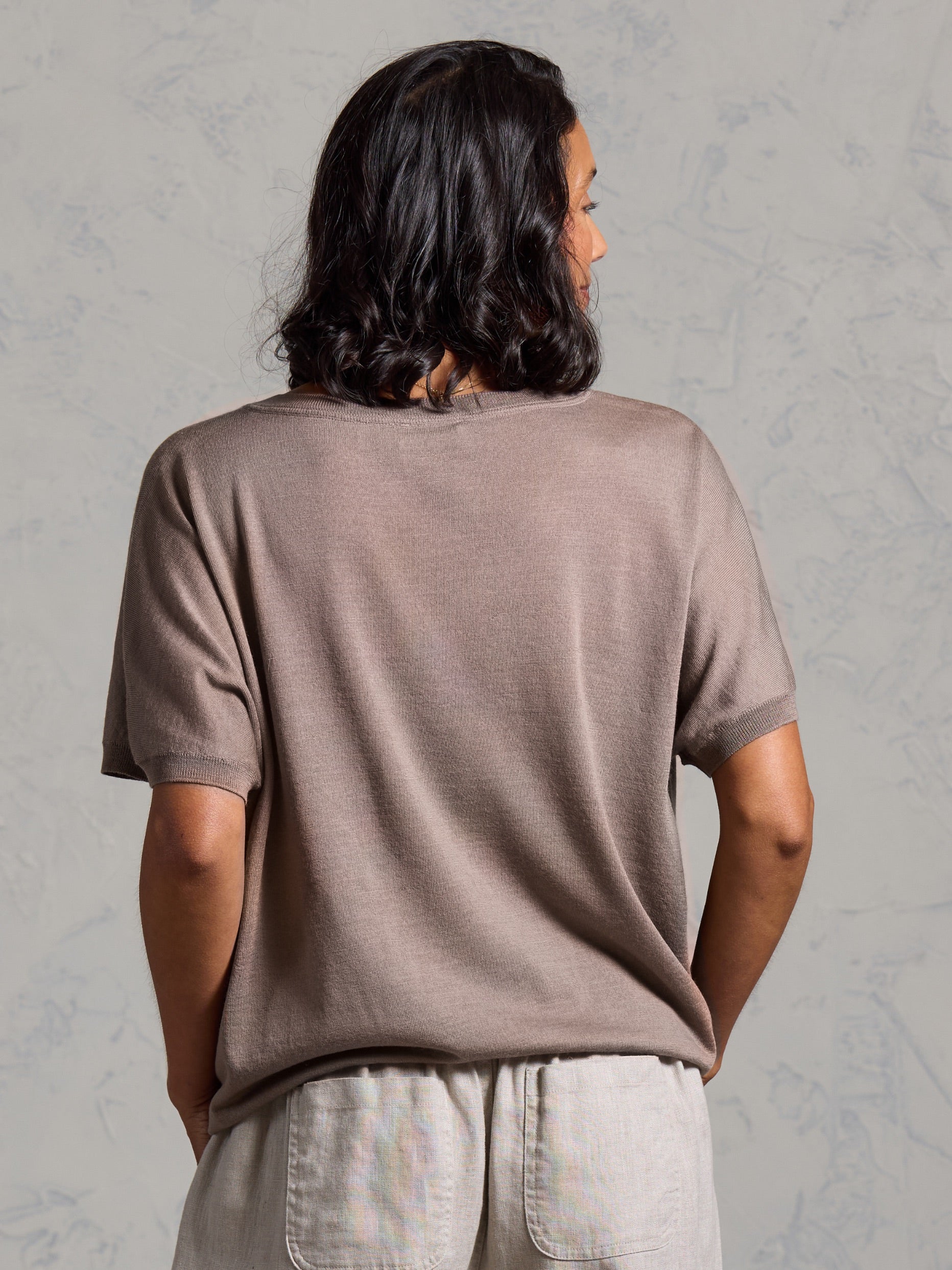 A woman wearing Toscana Merino Wool Top Elm and Sadhu French Linen Pants Flax