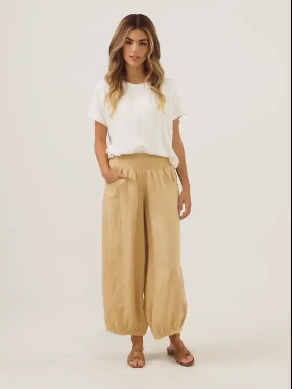 Model wears Sadhu French Linen Pants in Sand